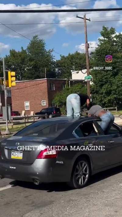 2 girls twerking on top of the car while the car is driving