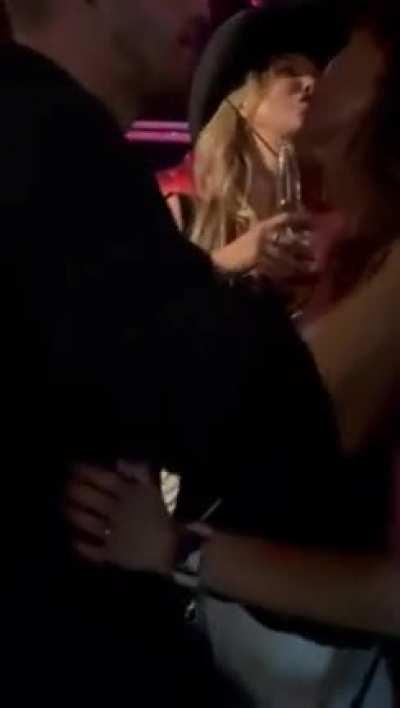 Sanna Marin dancing with and getting kissed by a guy in nightclub.