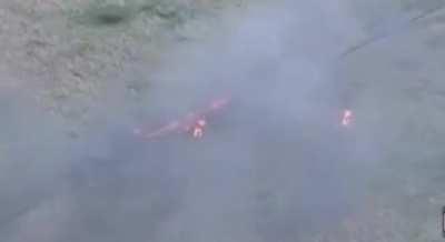 Burning Russian soldiers run from their stricken vehicle after an unsuccessful Russian mechanized assault. From the 425th Assault Batalion &quot;Skala&quot;. Zoomed in segment from a longer video.