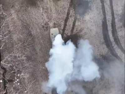 Russian BMP-1 is being hit by drone dropped munition while troops are falling out of the back.