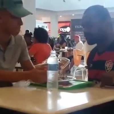 Restaurant worker noticed a disabled man struggling to eat so he sat down and helped him