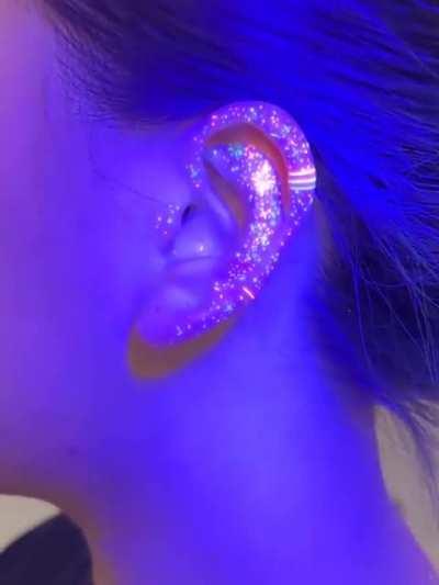 Glow in the dark ear tattoo