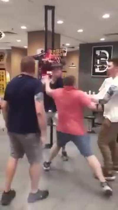 Two guys pick a fight on a kid.