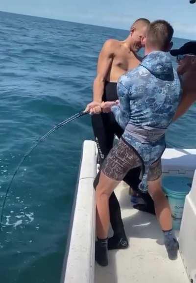 Three Bros Holding The Line To Reel In A Monster Grouper