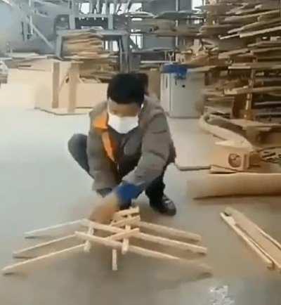 Making a DaVinci bridge out of a pile of wooden sticks.