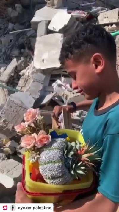 A Palestinian kid searching for his belongings in the rubble of his destroyed home