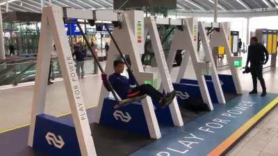 Swings used for charging mobile phones at Utrecht Centraal Railway Station