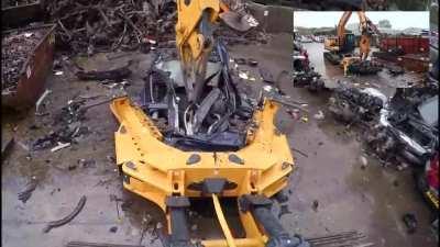 Vehicle being surgically dismantled for valuable parts at recycling scrapyard