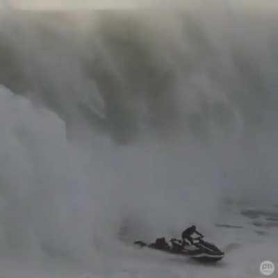 Jet ski driver saves a guy from a big wave