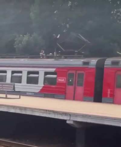 Kids casually playing with a train high voltage pantograph