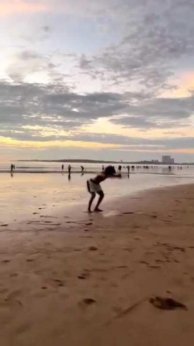 Continuous somersaults on a beach