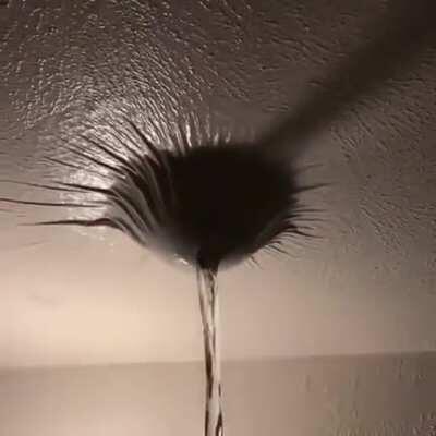 Poking a hole into water trapped by paint