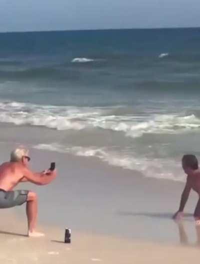 Dads embarrassing their daughters on the beach.