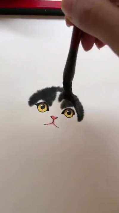 Artist drawing a kitty using watercolors