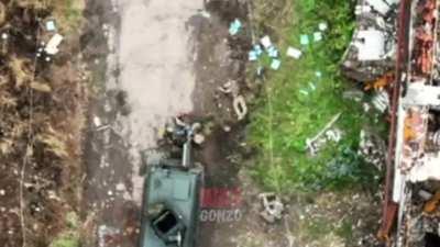 Russian drone grenade drop on Ukrainian soldiers next to a Ukrainian Kozak APC