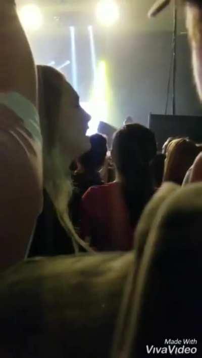 Daughter signing for her father during a rock concert.