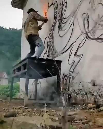 Insane wallart with a burning wood stick