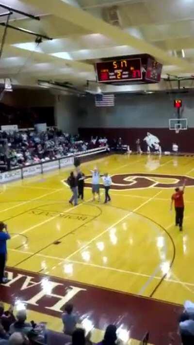 Blind man shoots a three pointer to win free Mcdonalds for a year.