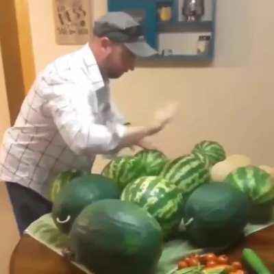 Dad's choosing which watermelon to buy