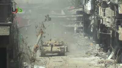 Syrian Army BMP-2 takes no chances moving through Daraya, spraying suspected rebel firing points to keep heads down - 3/21/2013