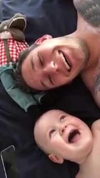 Daddy makes his baby laugh and baby tries imitate him... Wassuuuuuup!