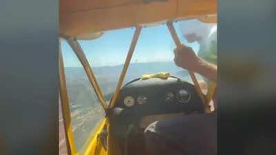 He comes out of the cockpit of the plane to restart the propeller