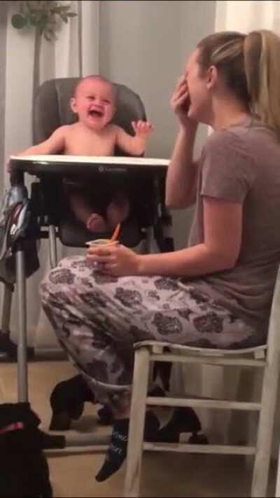 Baby laughs hysterically as mother fake sneezes.