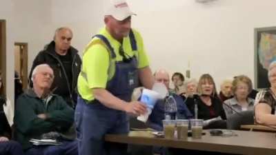 A farmer in Nebraska asking a pro-fracking committee member to honor his word of drinking water from a fracking location