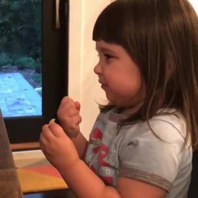 A toddler eating salt and vinegar chips for the first time