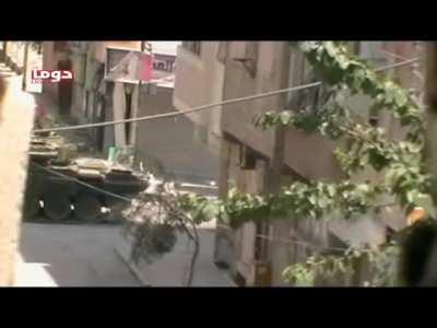 Early-war Syrian Army troops use a T-72 as cover to help facilitate a street crossing - Douma - 6/19/2012