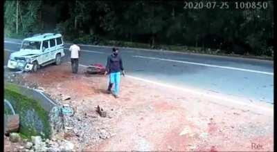 SUV rams (intentionally / unintentionally) into out of control swerving earthmover saving a parked biker. July 25 2020 Kerala, India.