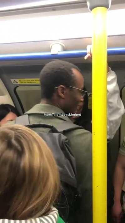 Guy with a megaphone having fun on the London Tube