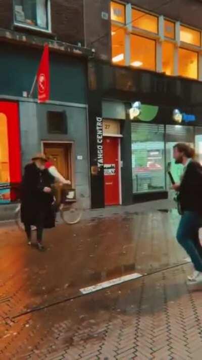 Here is an old man dancing to a street musician