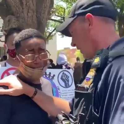 Emotional moment between an Officer and Protestor