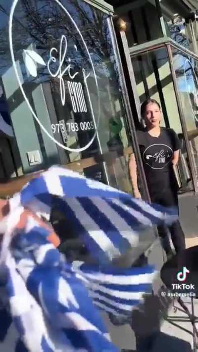 Woman tears down Greek flag mistaking it for Israeli flag