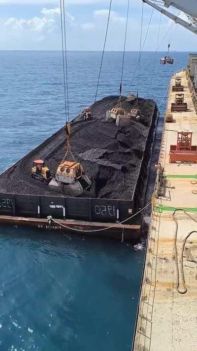 Unloading coal from a barge...