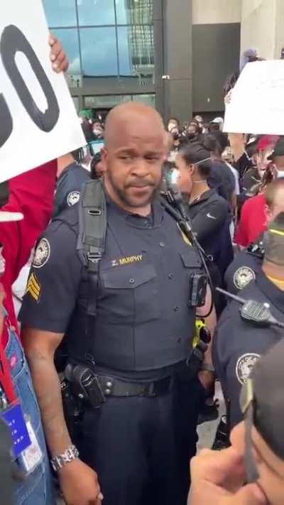 Police Officer speaking to a group of protesters about their right to protest