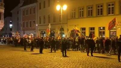 German Neo-Nazis support fascist Putin and march through Gera with Russian flags. Antifa counter protesters play clown music to mock the Nazis