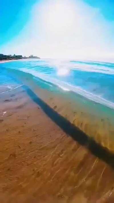 Rising wave crashing the shore