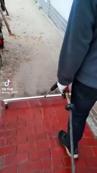 Power washing a sidewalk