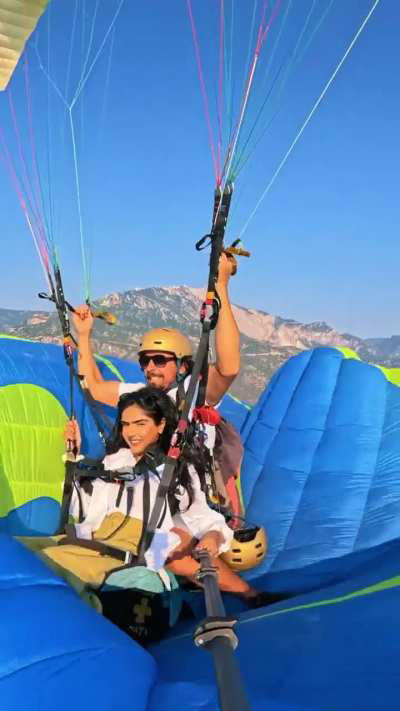 Man risks lives by stepping onto another parachute whilst paragliding 