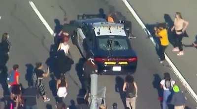 Protest in L.A look at these cops book. They realize when people come together they are powerless