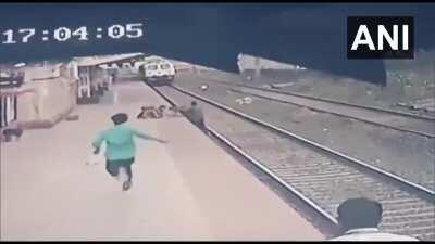 Guy saves a kid on railway track from incoming train.