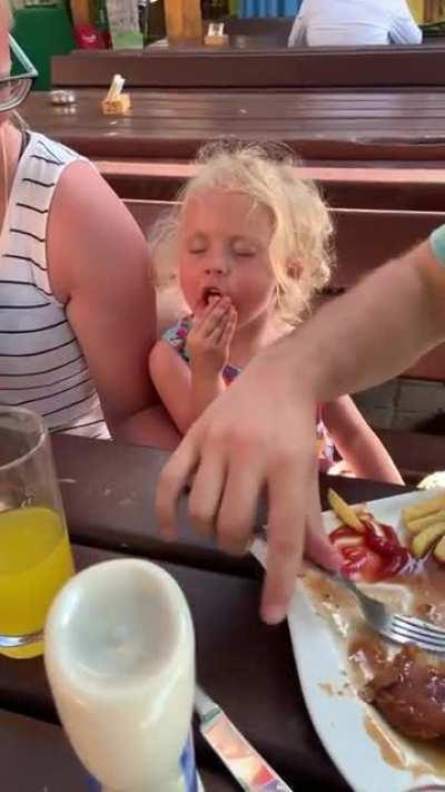 Little girl falls asleep while trying to eat her french fry