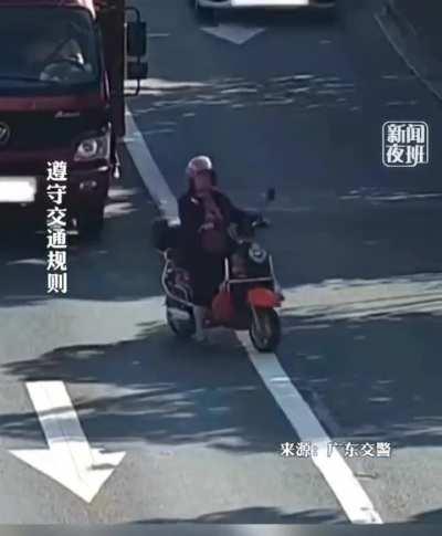 Driving a scooter like she owns the road