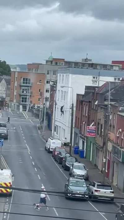 Guy hanging out of window.