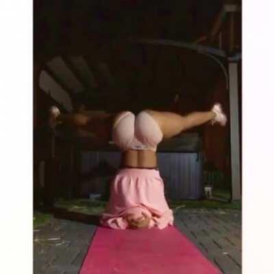 Dyl legs spread open on a handstand