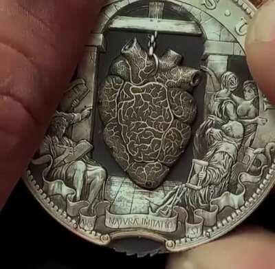 Intricate beating heart coin by Roman Booteen