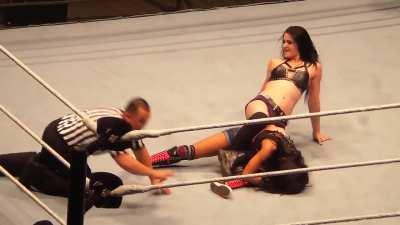 Paige squeezing the life out of AJ Lee with bodyscissors 