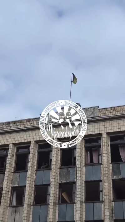 Russian soldiers pull down the Ukrainian flag over an administration building in the city of Selydove - October 2024